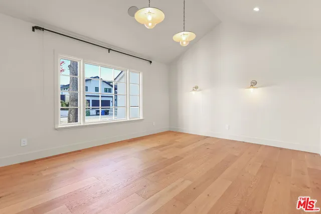 a view of an empty room with a fireplace and a window