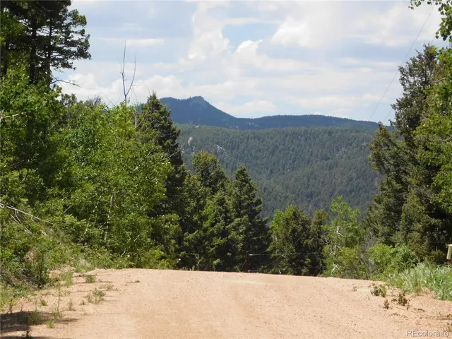 a view of a yard with mountains in the background
