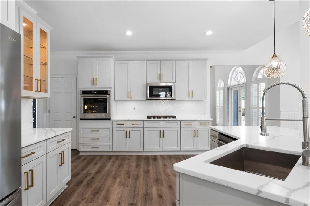 820 Nob Ridge Drive Southwest Marietta, GA 30064 - Photo 13 of 45 a kitchen with granite countertop white cabinets and white appliances