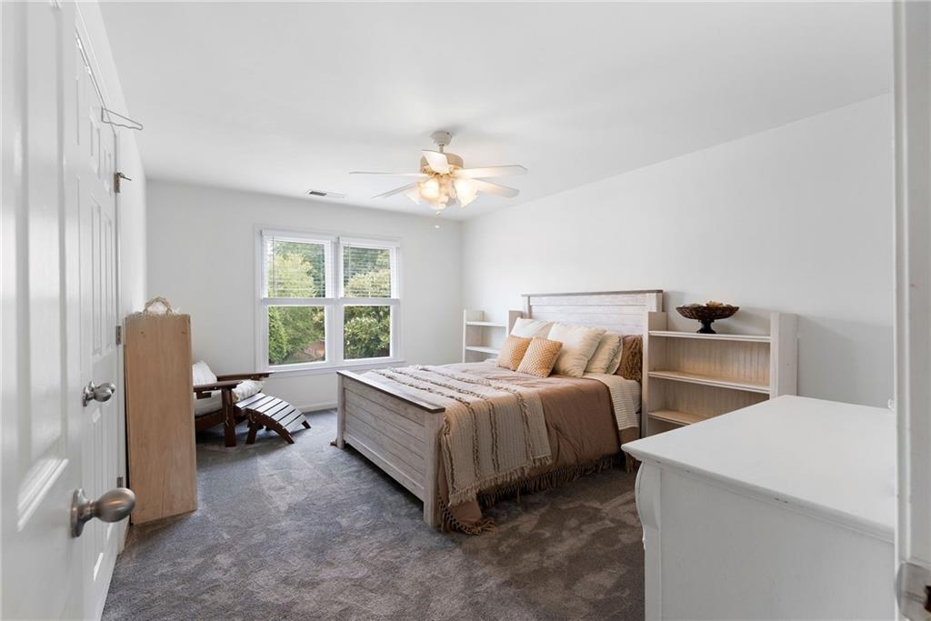 820 Nob Ridge Drive Southwest Marietta, GA 30064 - Photo 29 of 45 a bed room with a bed and a chandelier