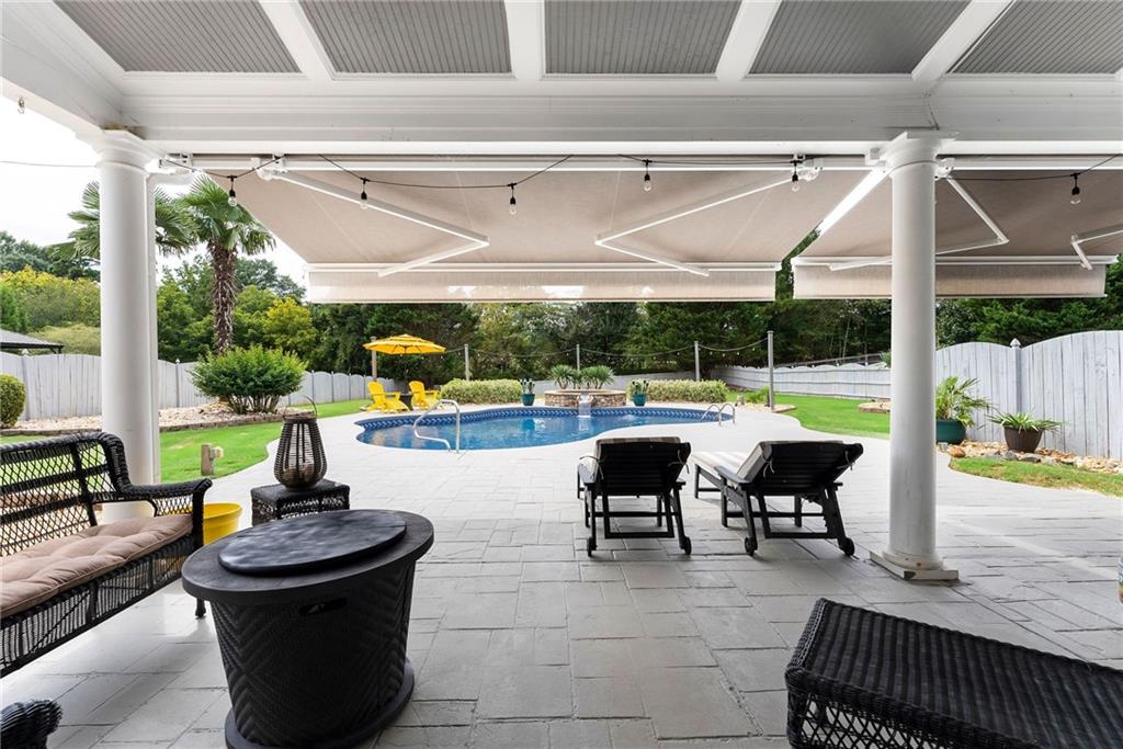 820 Nob Ridge Drive Southwest Marietta, GA 30064 - Photo 35 of 45 a view of a patio with table and chairs potted plants with palm tree