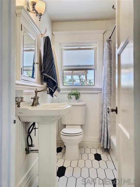 874 Arden Drive Encinitas, CA 92024 - Photo 15 of 25 a bathroom with a sink toilet and shower