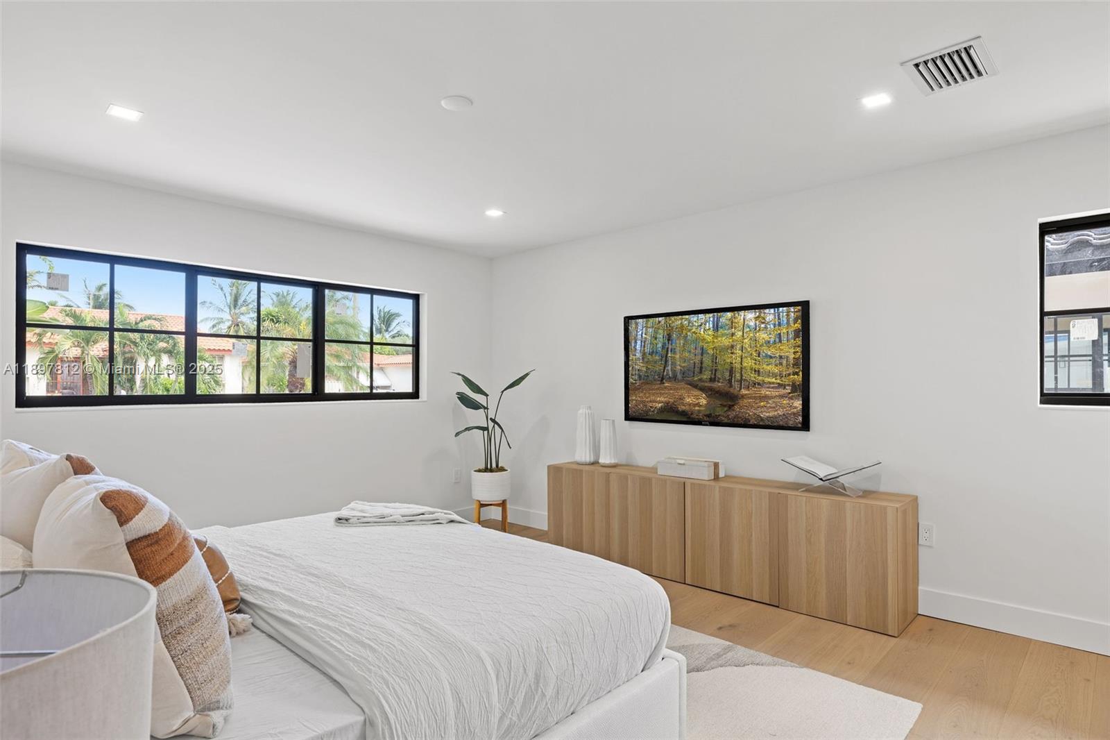 8858 Garland Avenue Surfside, FL 33154 - Photo 16 of 37 a bedroom with a bed and window