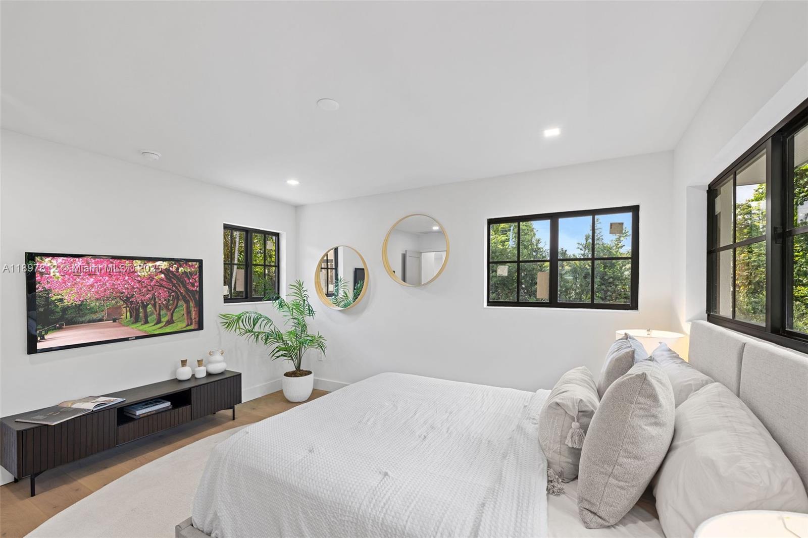 8858 Garland Avenue Surfside, FL 33154 - Photo 24 of 37 a bedroom with a bed and a flat screen tv