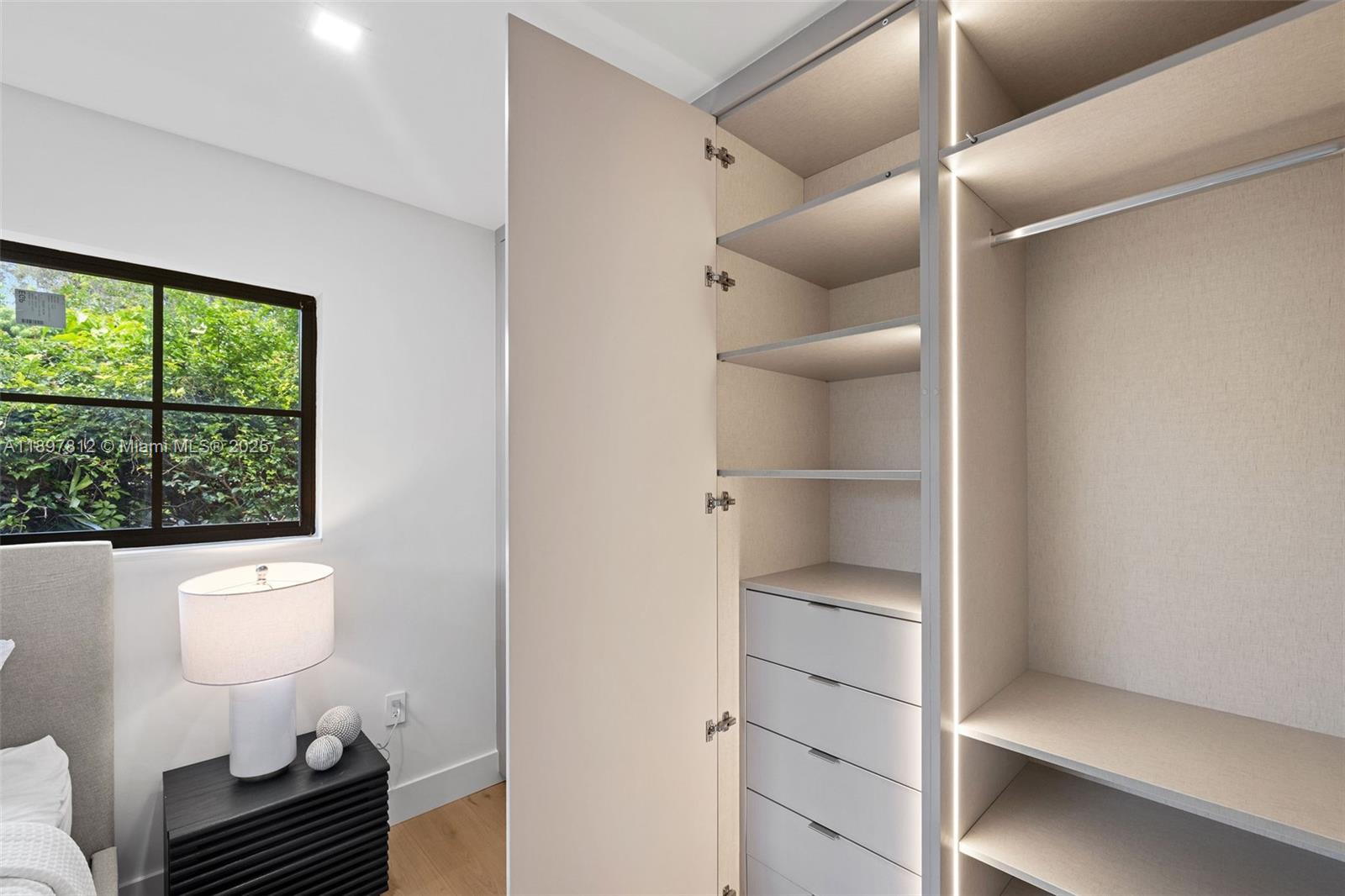 8858 Garland Avenue Surfside, FL 33154 - Photo 26 of 37 a bathroom with a sink toilet a mirror and window