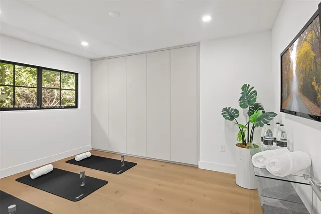 a room with a bed and a potted plant