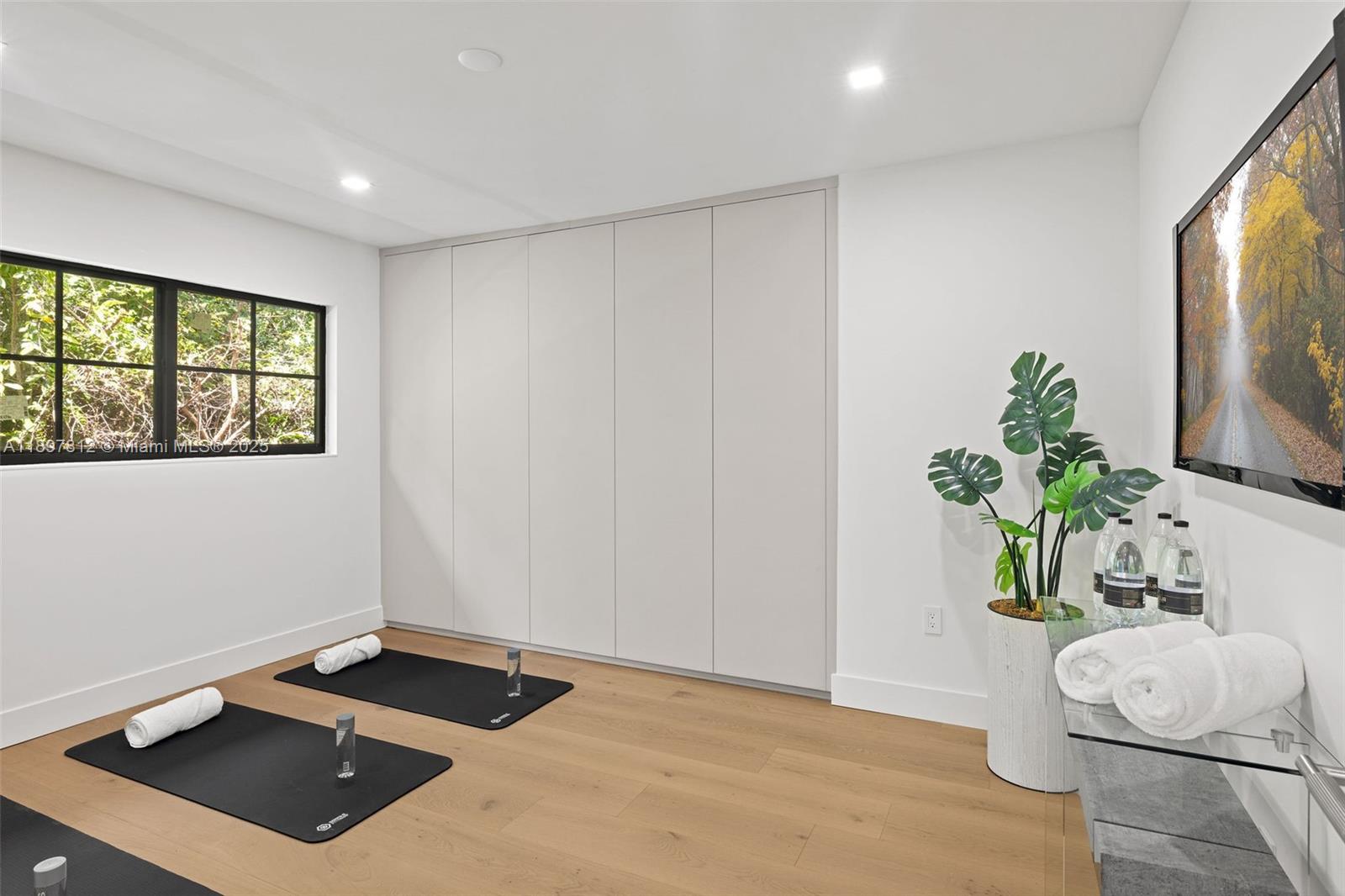 8858 Garland Avenue Surfside, FL 33154 - Photo 28 of 37 a room with a bed and a potted plant