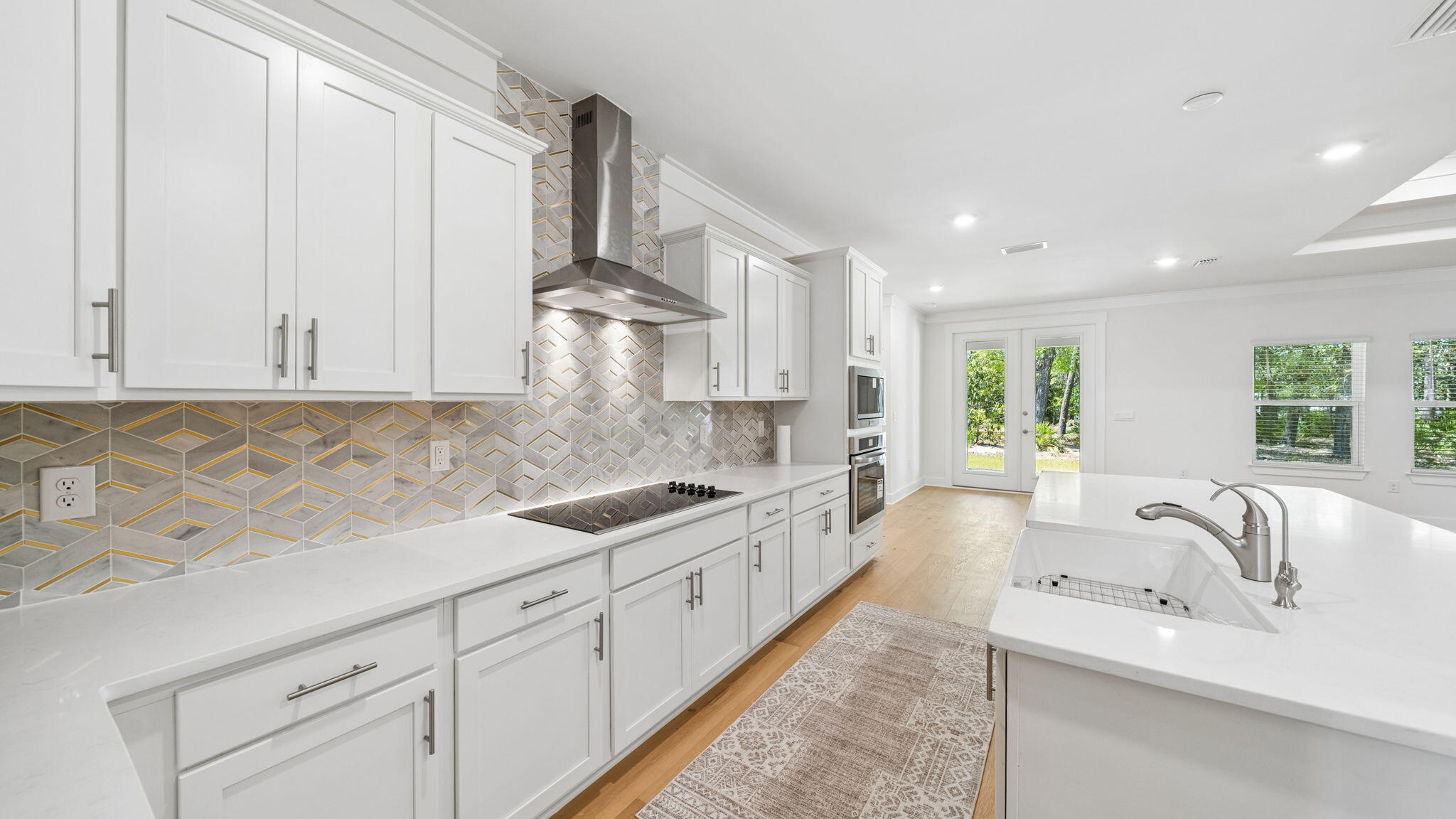 785 Old Ferry Road Santa Rosa Beach, FL 32459 - Photo 15 of 56 a kitchen with white cabinets and sink