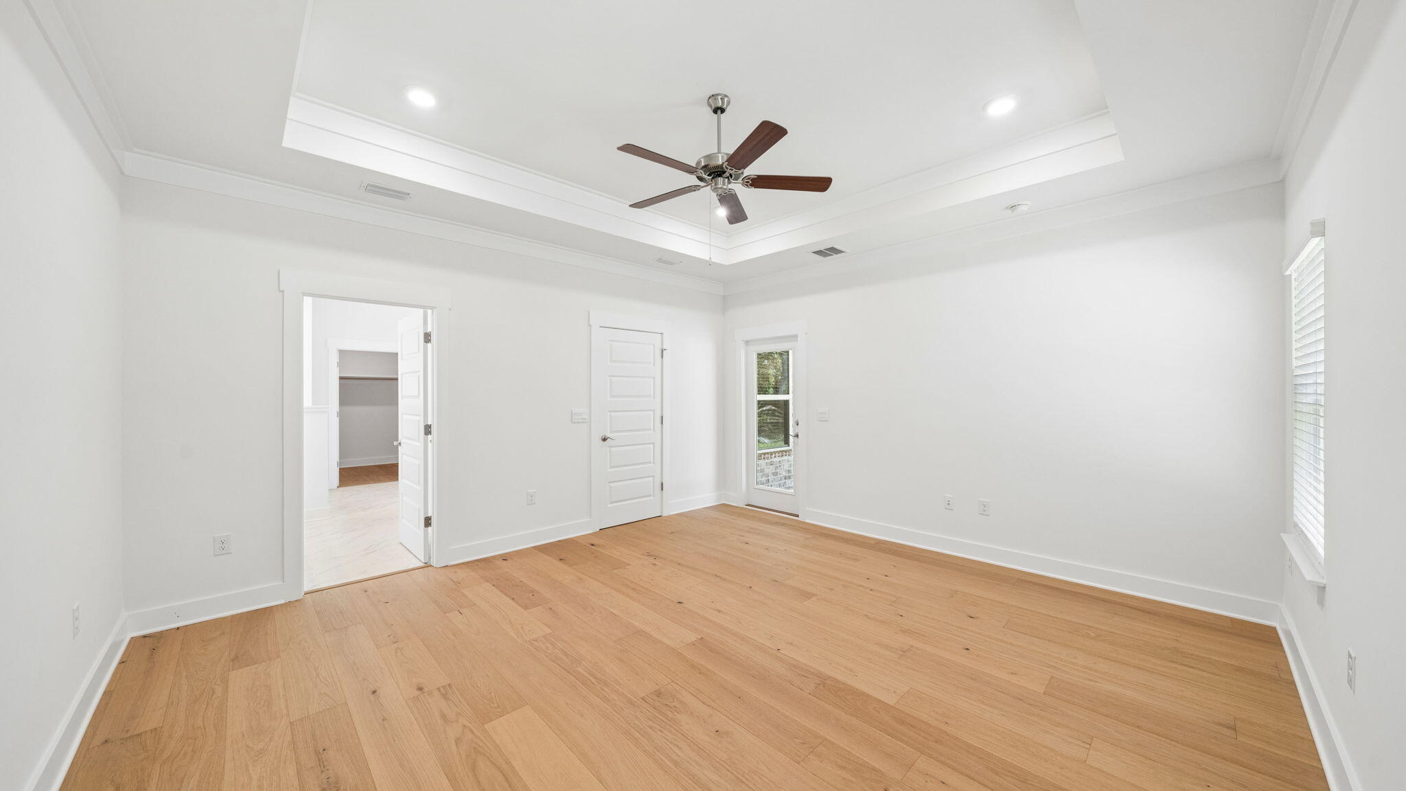 785 Old Ferry Road Santa Rosa Beach, FL 32459 - Photo 21 of 56 a view of a big room with wooden floor and a ceiling fan