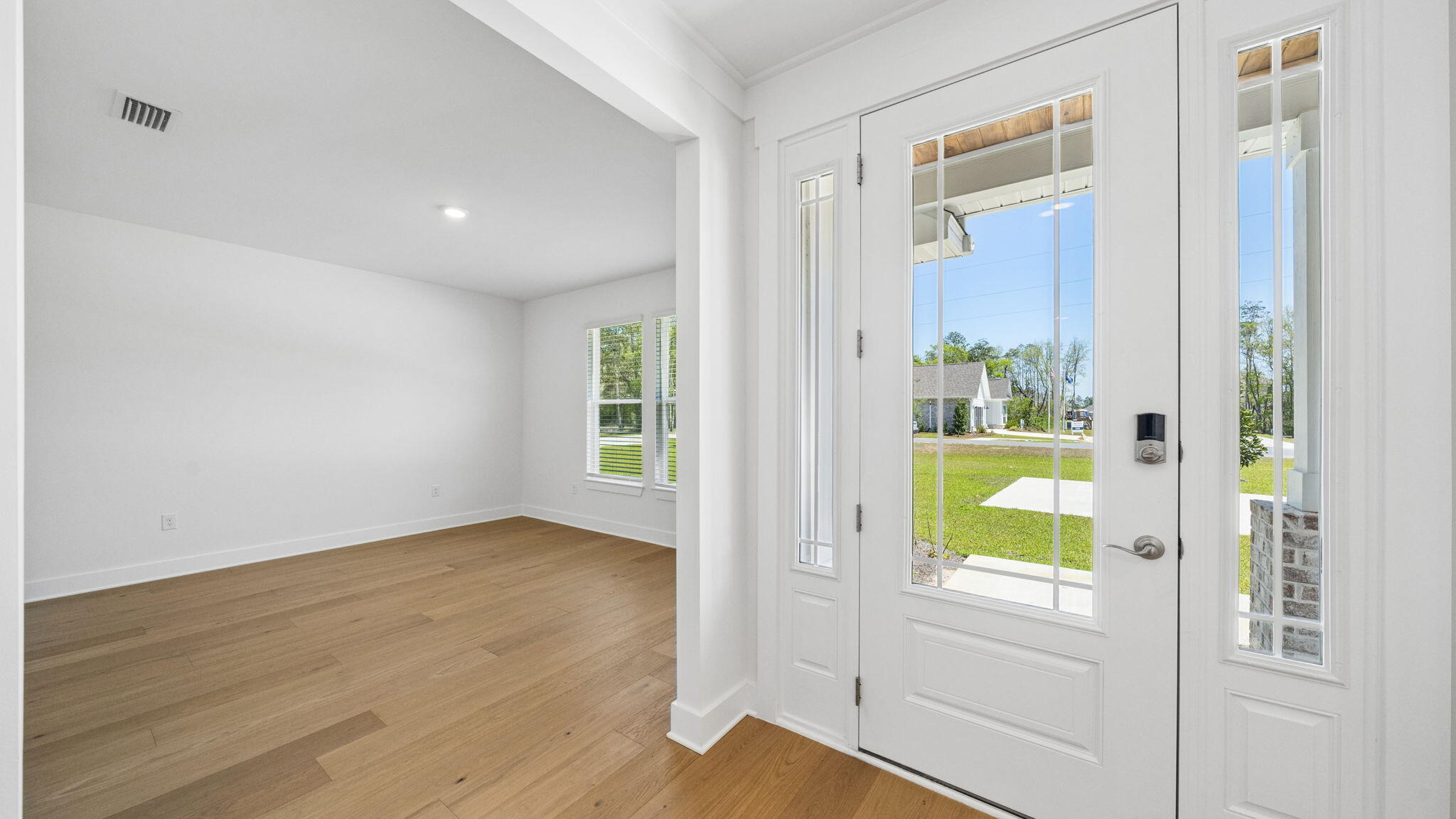 785 Old Ferry Road Santa Rosa Beach, FL 32459 - Photo 5 of 56 a view of an entryway with wooden floor and a door