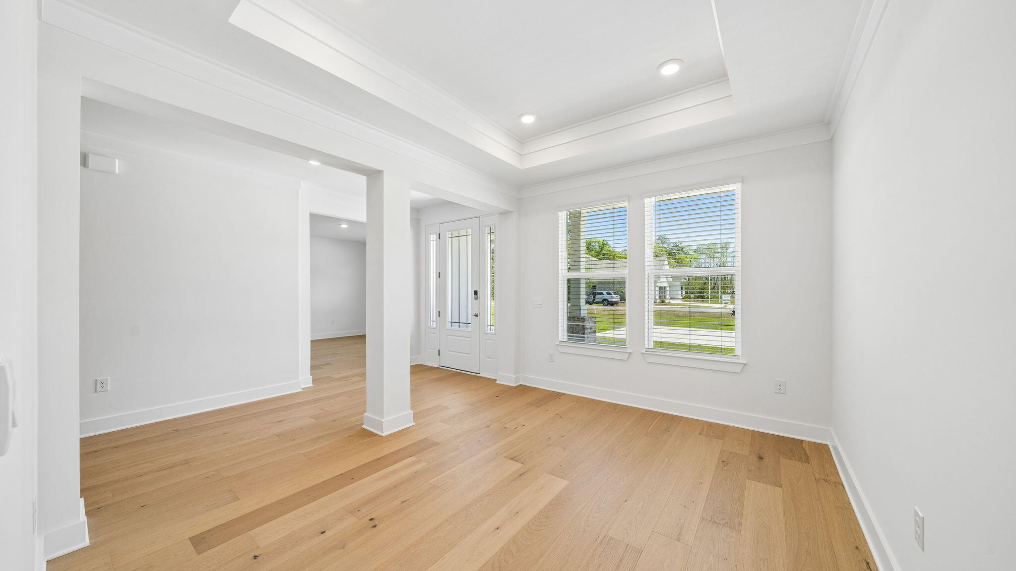 785 Old Ferry Road Santa Rosa Beach, FL 32459 - Photo 8 of 56 an empty room with wooden floor and windows