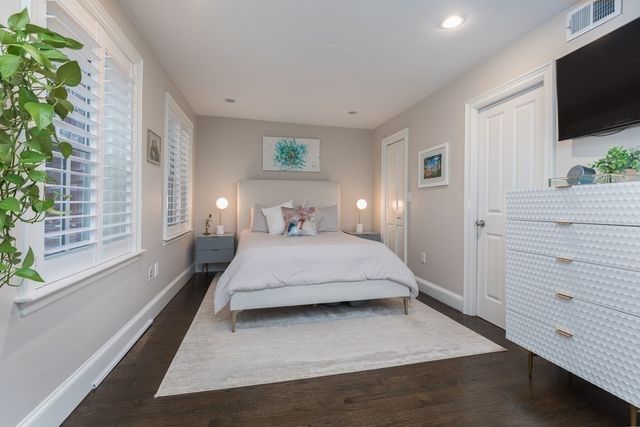 a bedroom with a large bed and a flat screen tv