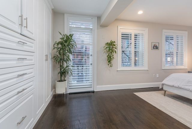an empty room with windows and wooden floor