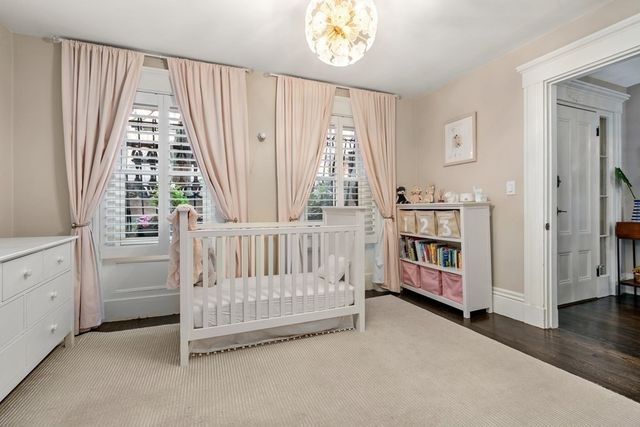 a view of a bedroom with furniture and windows
