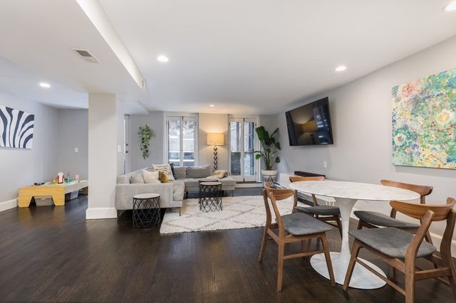 a living room with fireplace furniture and a flat screen tv