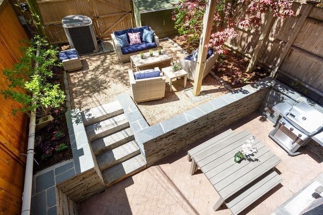 swimming pool view with a couch and potted plants