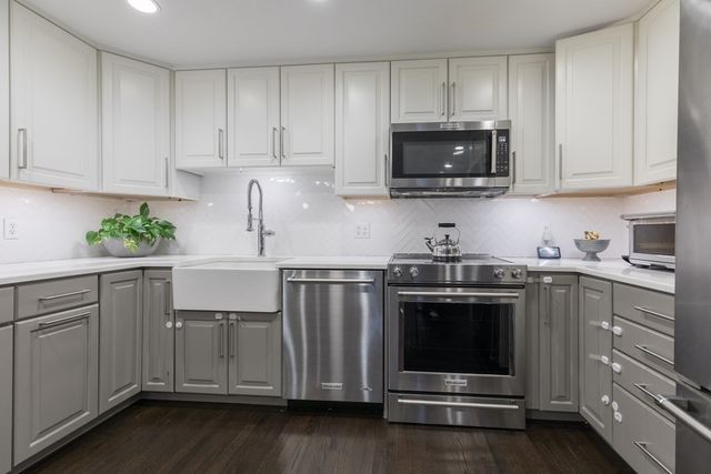 a kitchen with sink and cabinets