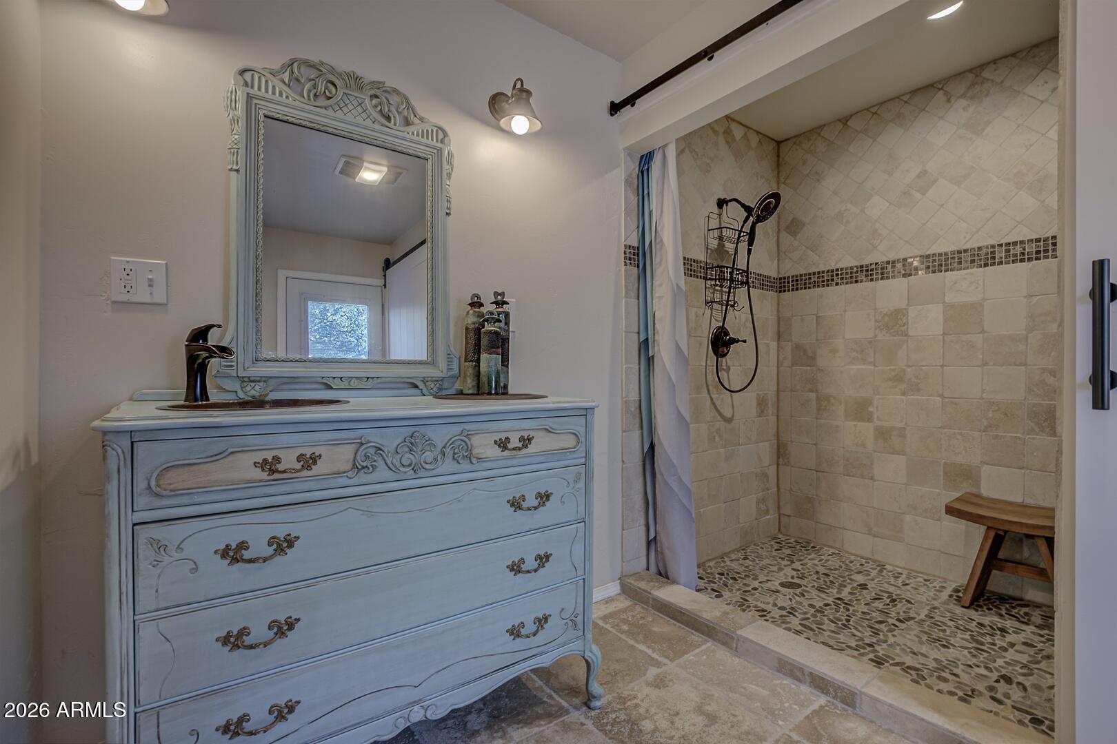 3762 Watertank Road Pine, AZ 85544 - Photo 19 of 38 a bathroom with a granite countertop sink a mirror and shower