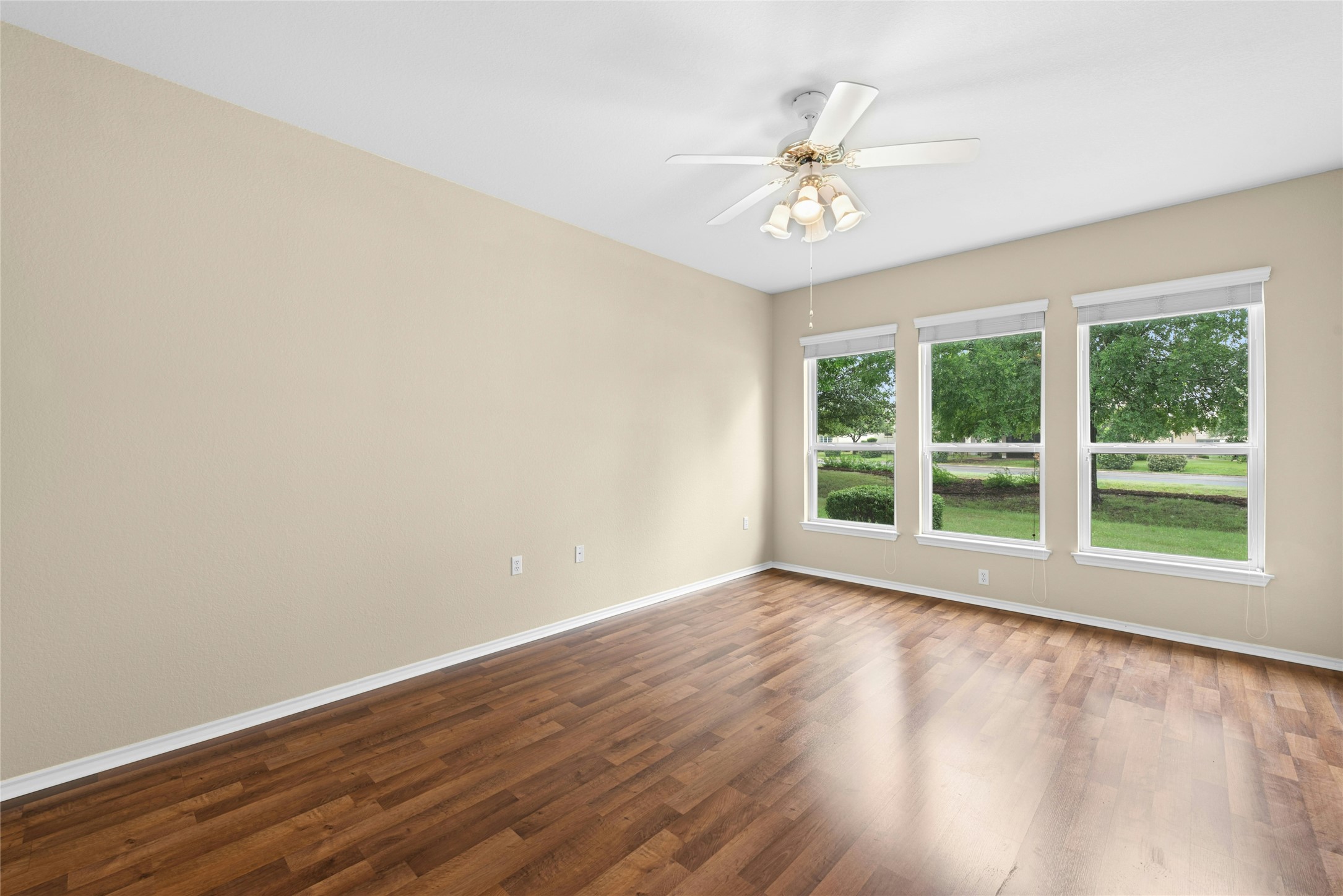 111 Hampton Circle Georgetown, TX 78633 - Photo 17 of 34 a view of an empty room with wooden floor and a window