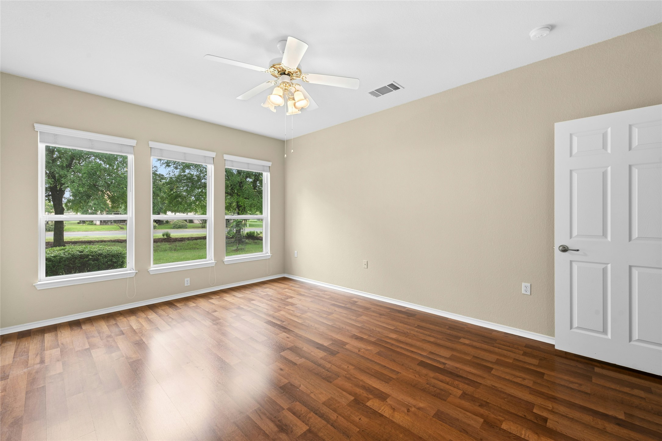 111 Hampton Circle Georgetown, TX 78633 - Photo 18 of 34 a view of an empty room with wooden floor and a window