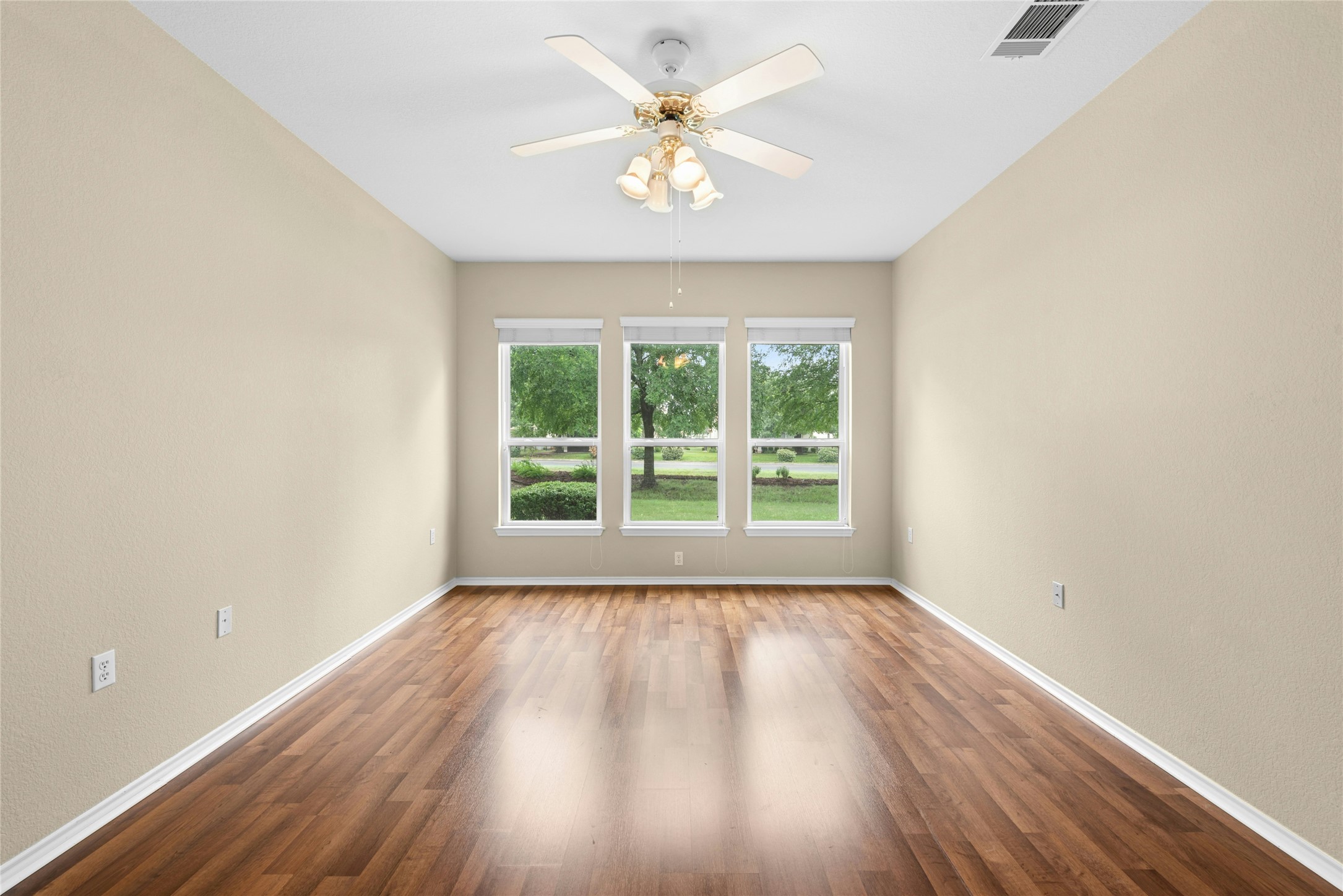111 Hampton Circle Georgetown, TX 78633 - Photo 19 of 34 wooden floor in an empty room with a window