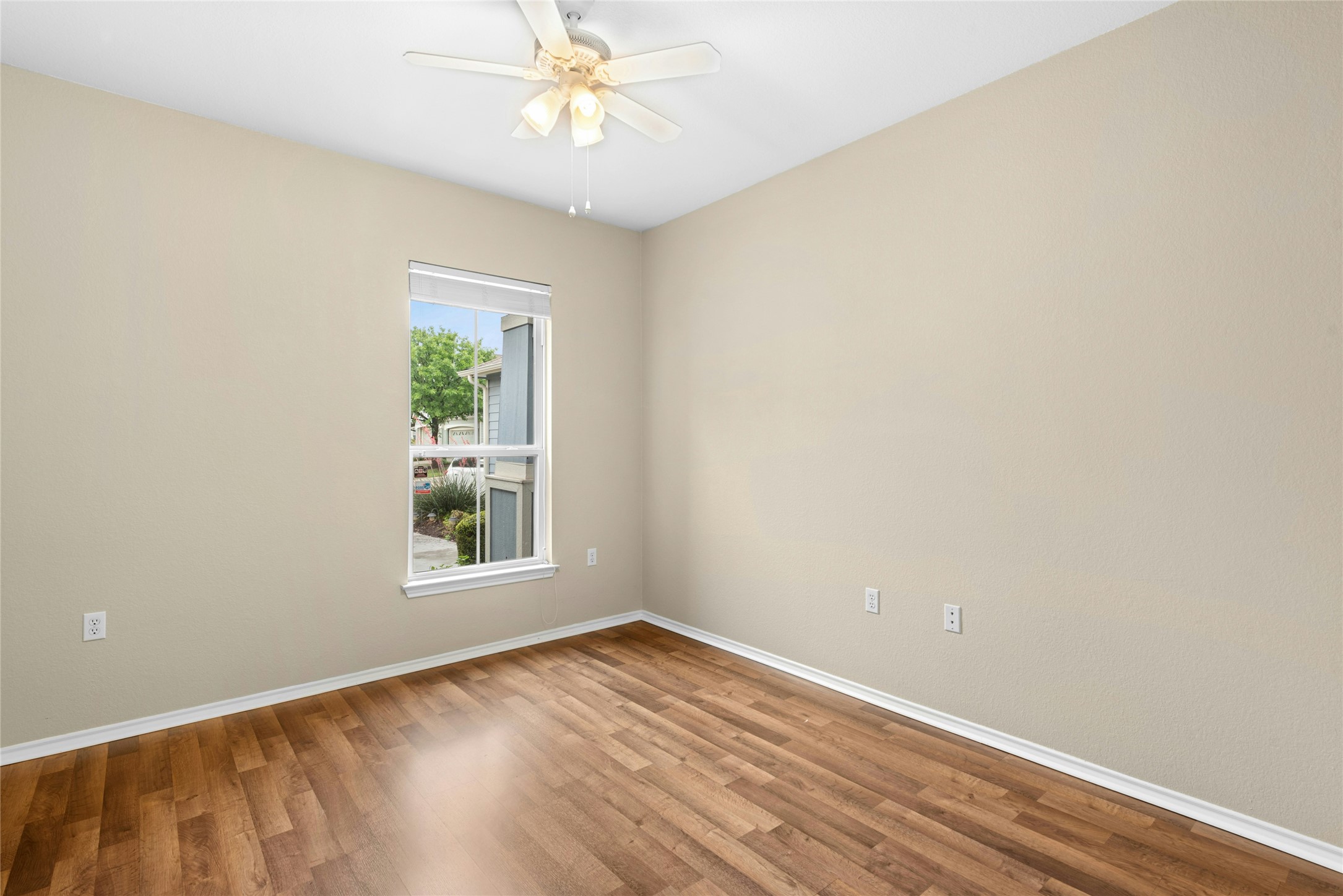 111 Hampton Circle Georgetown, TX 78633 - Photo 24 of 34 an empty room with a window and wooden floor