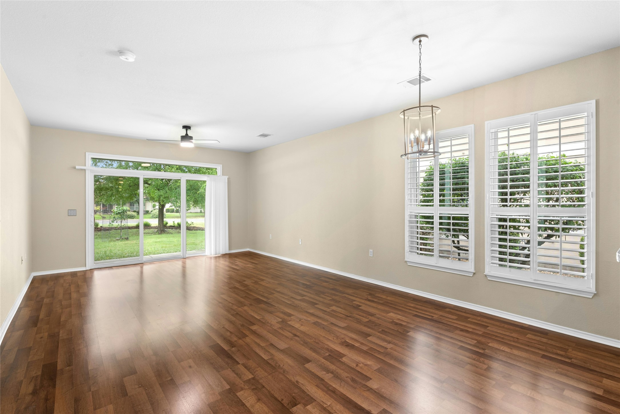 111 Hampton Circle Georgetown, TX 78633 - Photo 5 of 34 a view of an empty room with wooden floor and a window