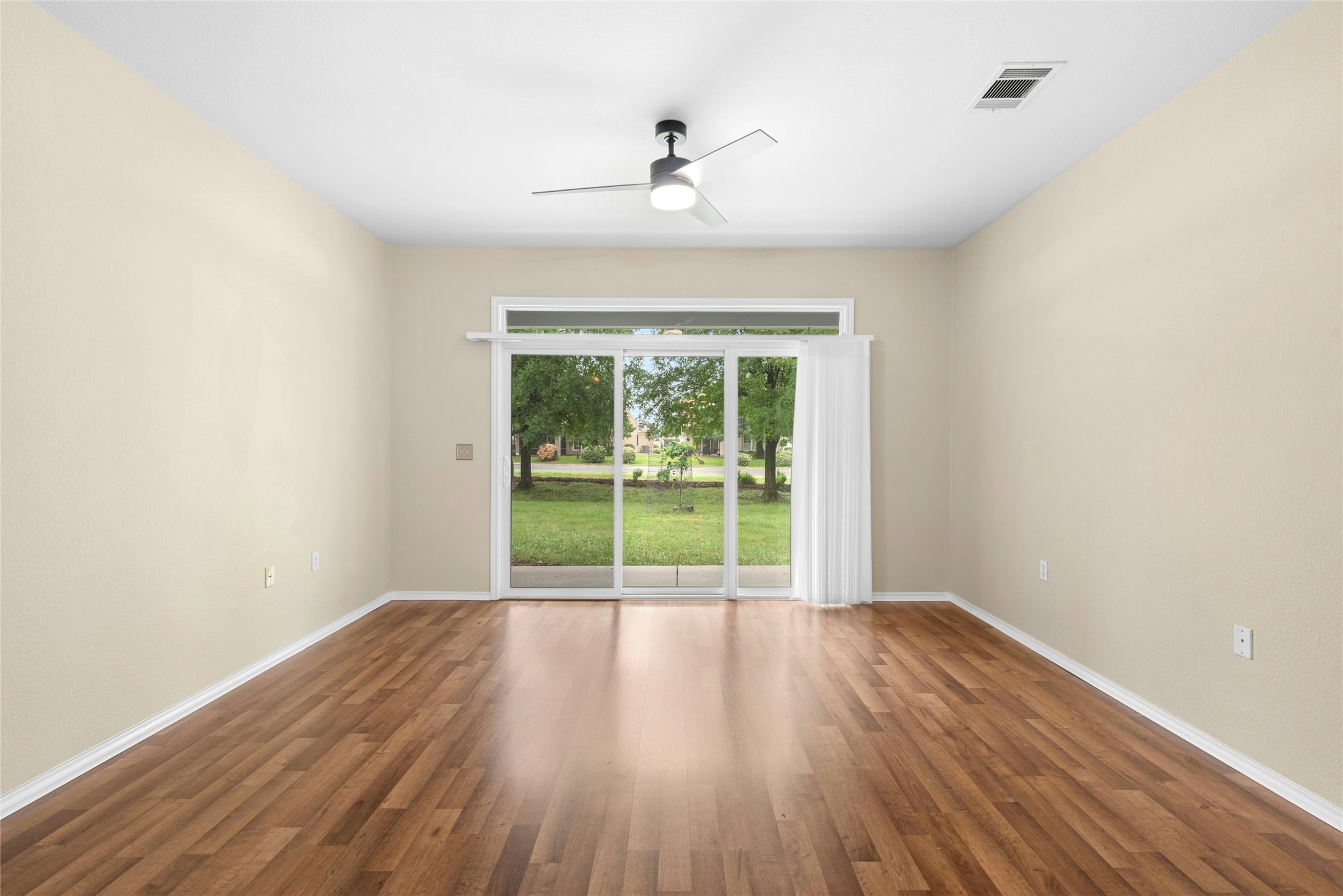 111 Hampton Circle Georgetown, TX 78633 - Photo 6 of 34 a view of an empty room with wooden floor and a window