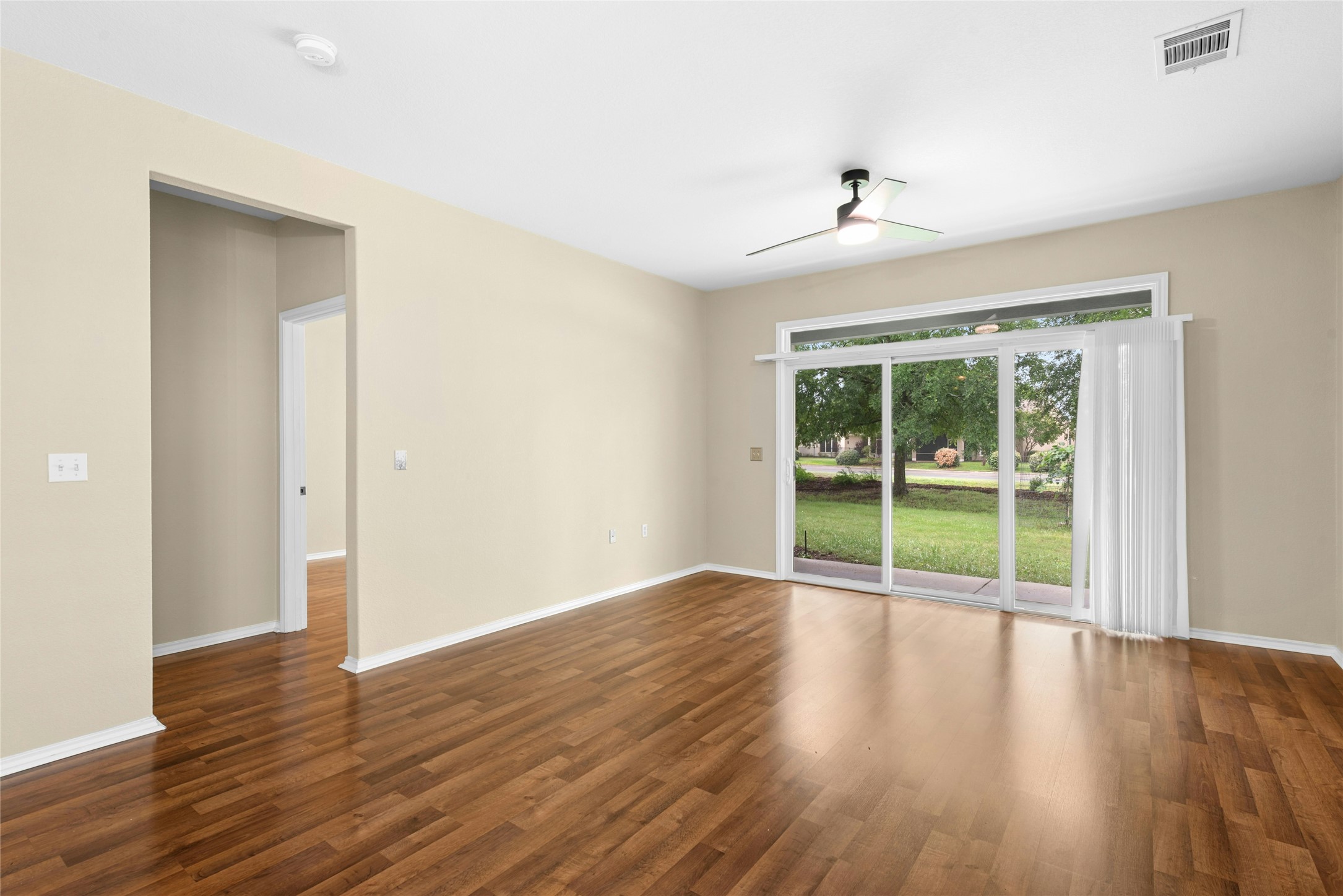 111 Hampton Circle Georgetown, TX 78633 - Photo 8 of 34 wooden floor in an empty room with a window