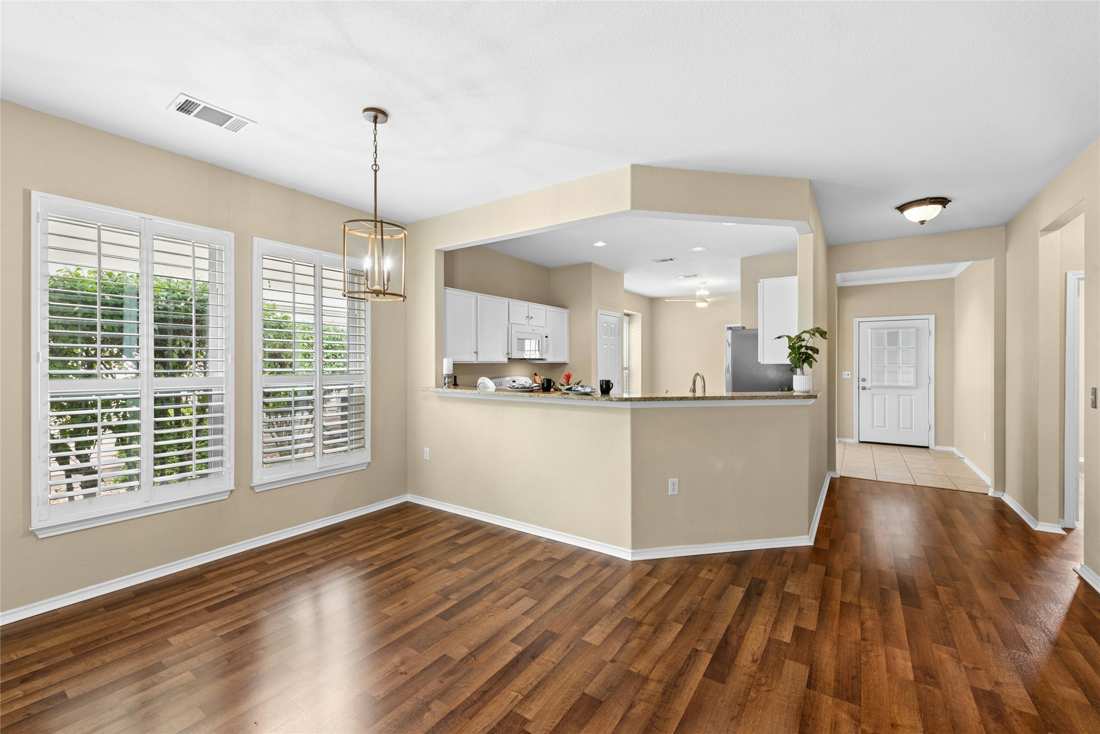 111 Hampton Circle Georgetown, TX 78633 - Photo 9 of 34 a view of a kitchen with wooden floor and windows
