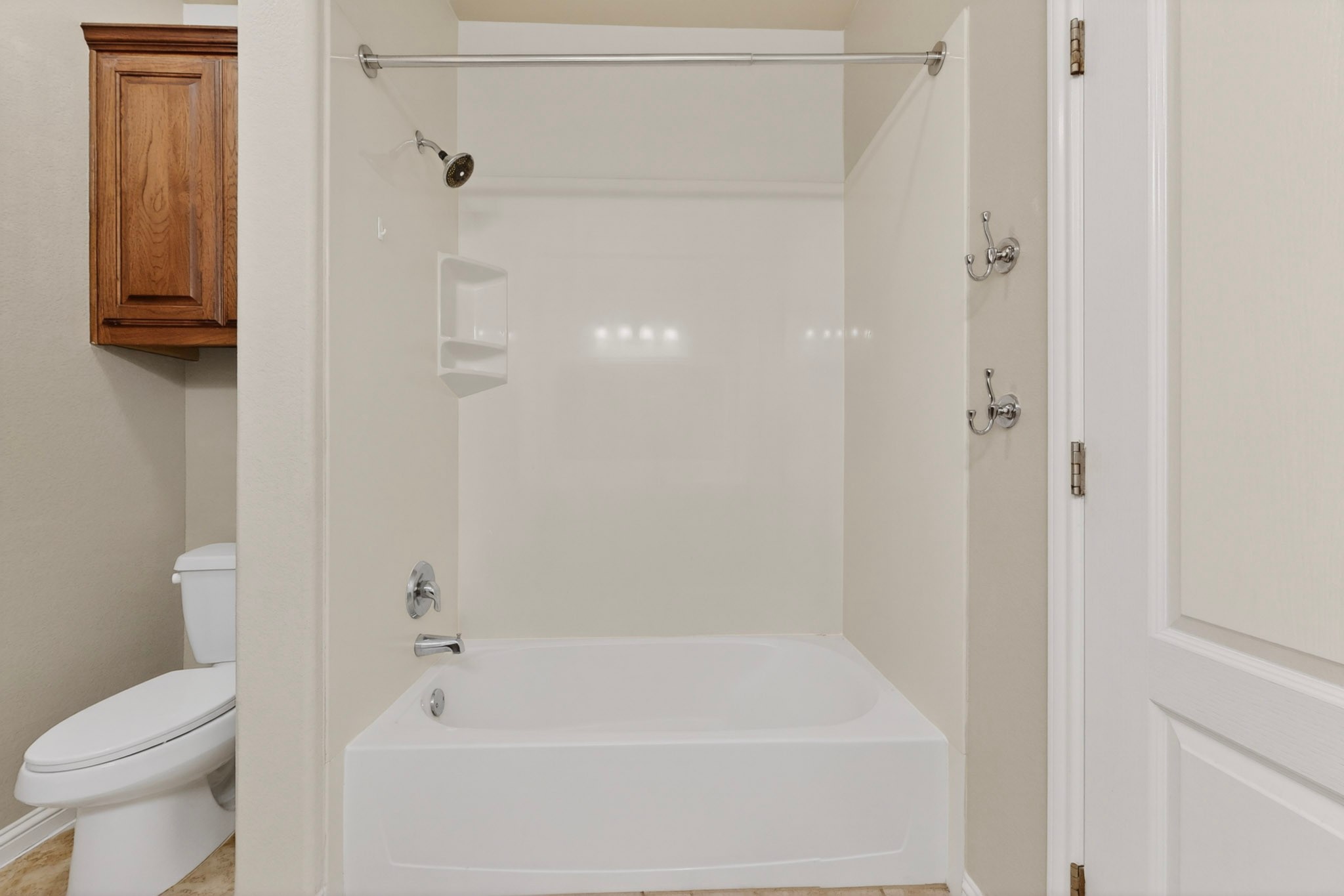 178 Limestone Trail Austin, TX 78737 - Photo 29 of 40 White tub and shower combination with chrome fixtures and integrated shelving