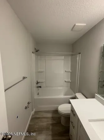 a view of a livingroom with furniture window and wooden floor