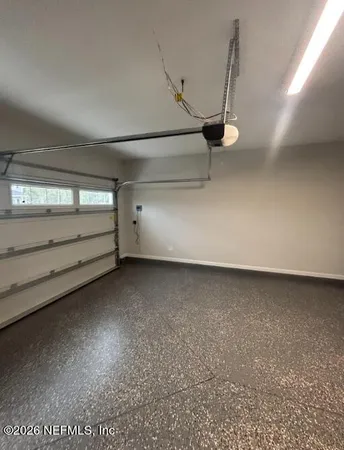 a living room with furniture kitchen view and a chandelier