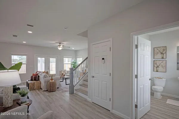 a view of entryway and hall with wooden floor