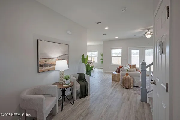 a living room with furniture potted plant and a window