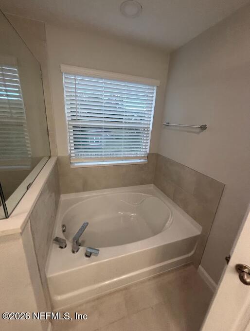 1223 Jewelstone Lane Jacksonville, FL 32221 - Photo 8 of 46 a bath tub sitting in a bathroom next to a window