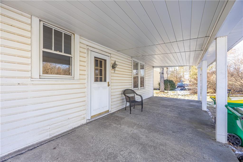 422 New Castle Road Butler, PA 16001 - Photo 23 of 27 a view of a deck with table and chairs and floor to ceiling window