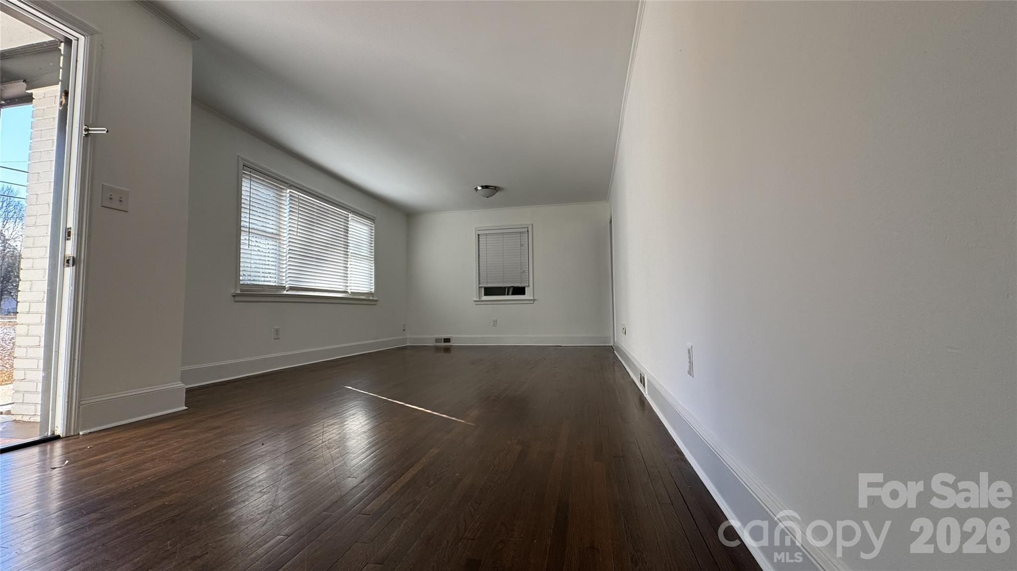 7507 Wilson Grove Road Mint Hill, NC 28227 - Photo 11 of 48 an empty room with wooden floor and windows