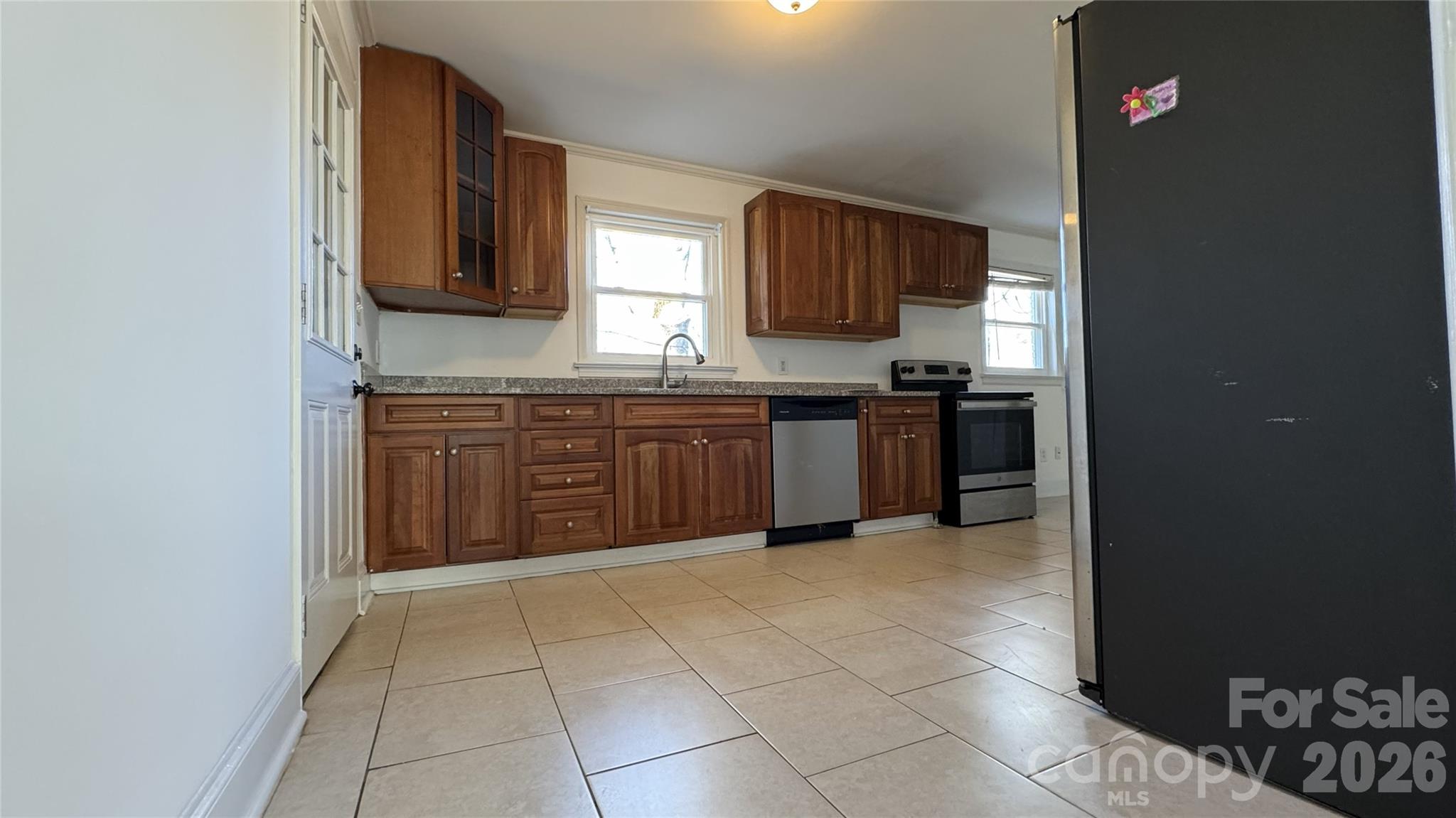 7507 Wilson Grove Road Mint Hill, NC 28227 - Photo 13 of 48 a kitchen with stainless steel appliances granite countertop a stove top oven a sink and dishwasher