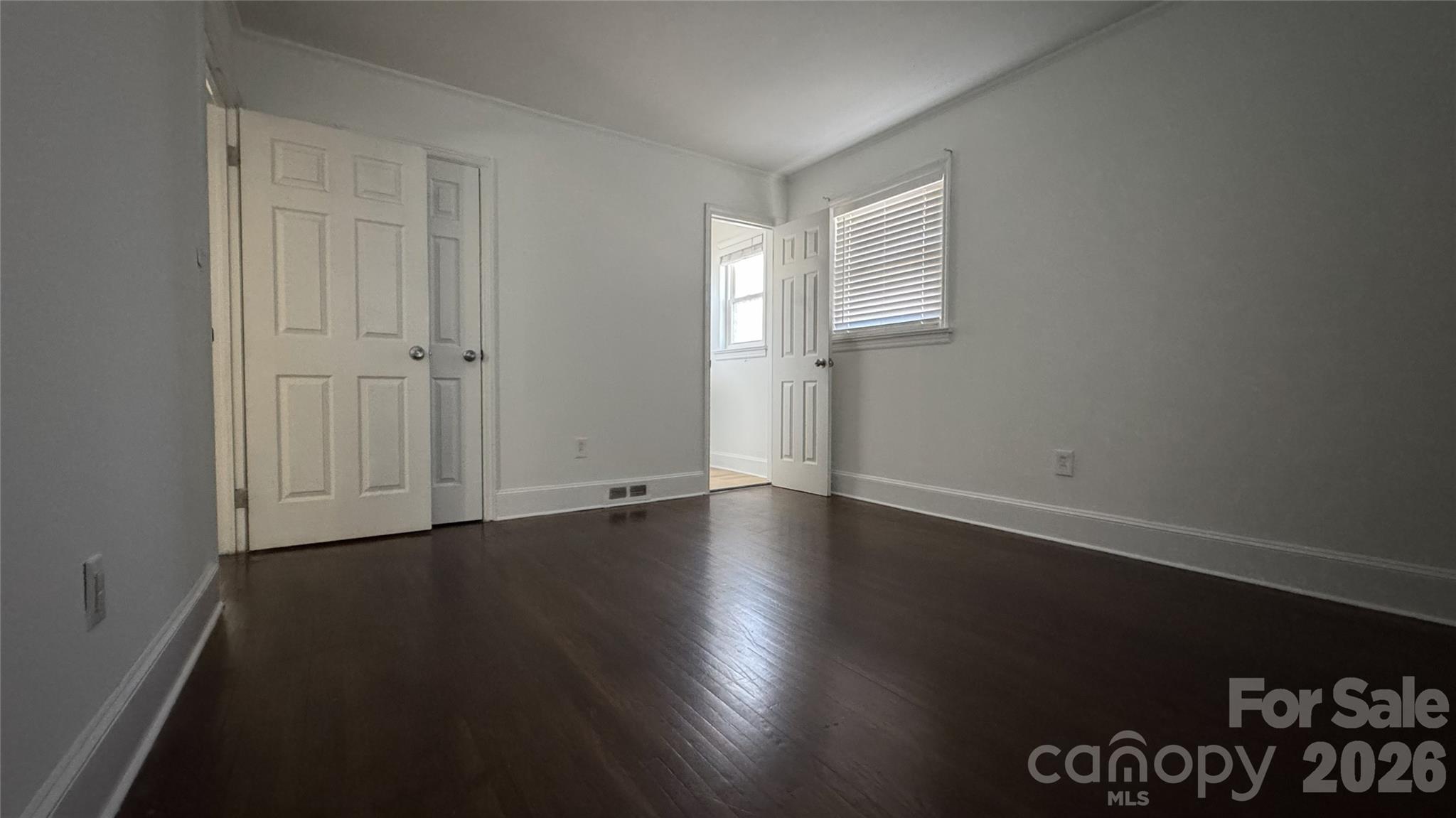 7507 Wilson Grove Road Mint Hill, NC 28227 - Photo 42 of 48 a view of an empty room with wooden floor and a window