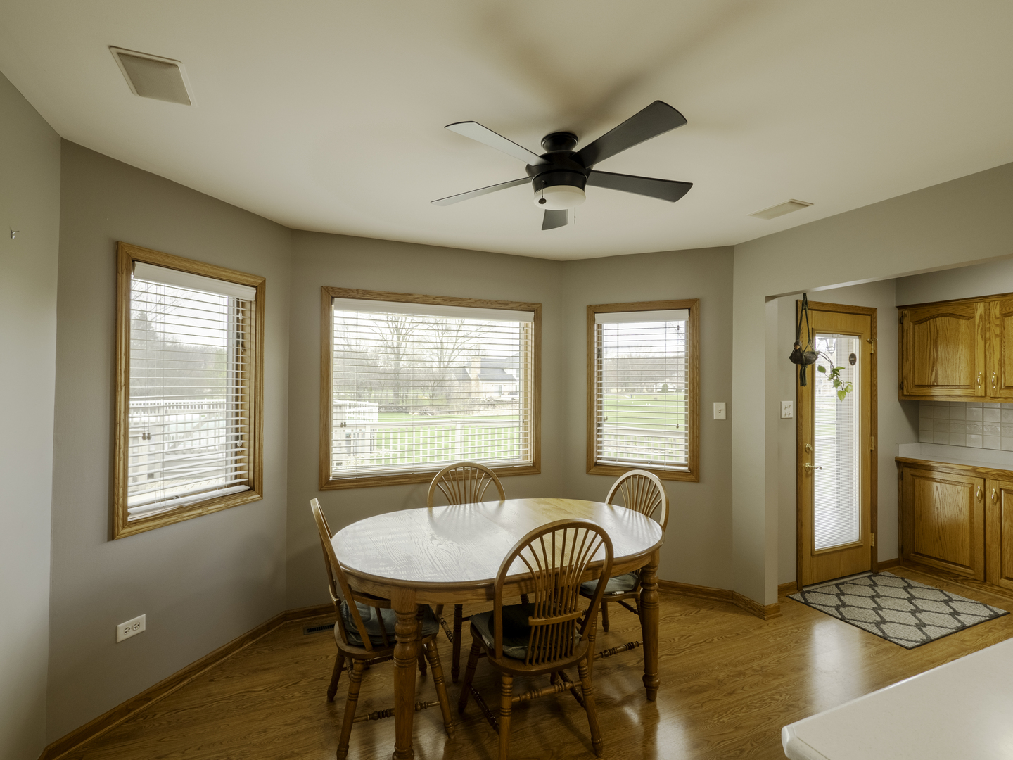 13310 Derby Road Lemont, IL 60439 - Photo 11 of 48 a dining room with furniture a chandelier and wooden floor