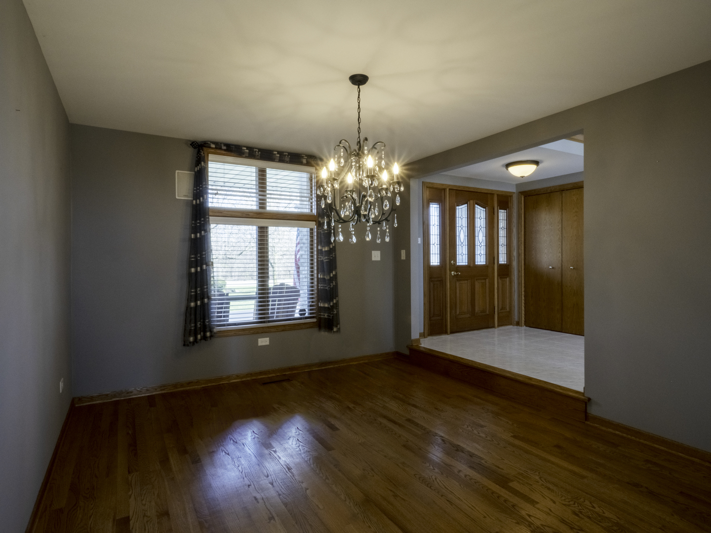 13310 Derby Road Lemont, IL 60439 - Photo 12 of 48 a view of an empty room with wooden floor and a window