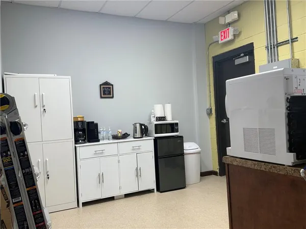 a kitchen with stainless steel appliances a stove a microwave a sink and cabinets