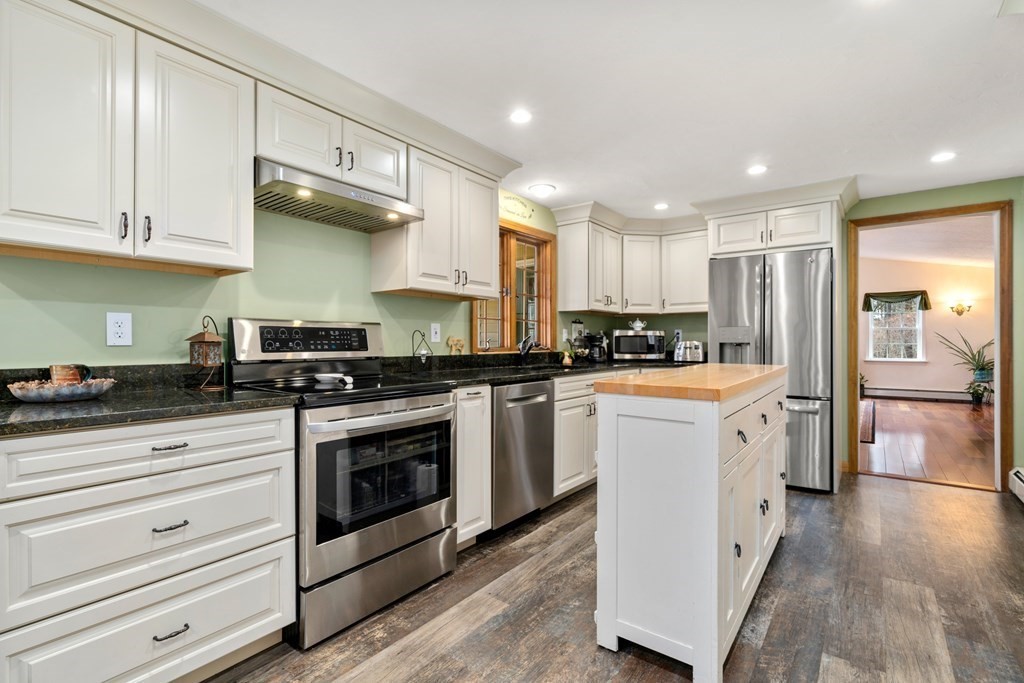 131 Union Road Holland, MA 01521 - Photo 8 of 34 a kitchen with granite countertop white cabinets stainless steel appliances and sink