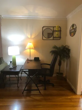 a living room with furniture and a lamp