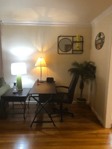a living room with furniture and a lamp