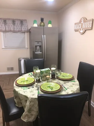 a view of a dining room with furniture and chandelier