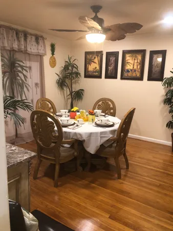 a view of a dining room with furniture and chandelier