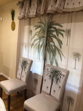 a view of a room with table and chairs