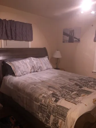 a bedroom with a bed and a night stand